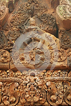 Sandstone carving at the wall of the ancient Banteay Srei Temple ruin in Siem Reap, Cambodia.