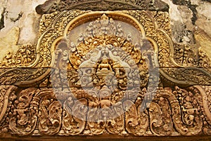 Sandstone carving at the wall of the ancient Banteay Srei Temple ruin in Siem Reap, Cambodia.