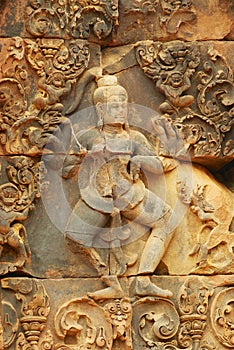 Sandstone carving at the wall of the ancient Banteay Srei Temple ruin in Siem Reap, Cambodia.
