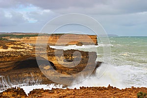 Sandstone cliffs with big waves on Great Ocean Road