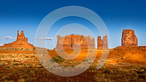 The sandstone formations of Mitten Buttes and Cly Butte in the desert landscape of Monument Valley