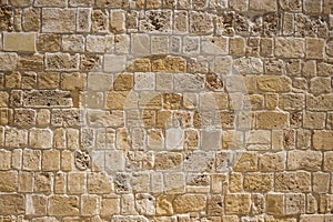 Sandstone, limestone aged wall at Cyprus. Yellow stonewall background, close up view with details.