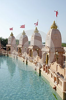 Sandstone mandapas around the artificial lake at Neelkanth Dham Swaminarayan Temple, Poicha, Gujarat, India, located at Poicha