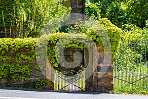 Sandstone portal with lattice gate and ivy