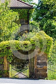 Sandstone portal with lattice gate and ivy