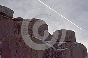 Sandstone Redrock with Clouds Contrail and Snow Patches