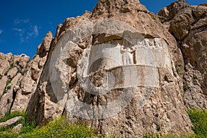Sandstone rock with carved tombs of persian kings in Necropolis, Iran. King burial site of ancient Persia. Zoroastrian