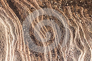 Sandstone rock face layers with pebble stones scattered ideal as natural geologic background