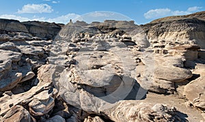 Sandstone rocks pour across the ground along a Bisti Badlands the canyon paths