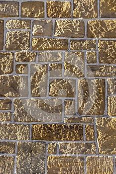 Sandstone wall, bricked with different sized sharpened rustic stone and white joints