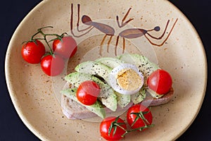 Sandwich with avocado, boiled egg and cherry tomatoes