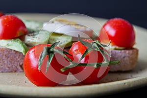 Sandwich with avocado, boiled egg and cherry tomatoes