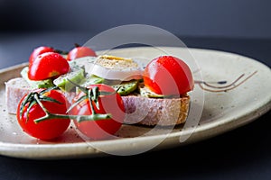 Sandwich with avocado, boiled egg and cherry tomatoes