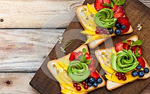 Sandwich with avocado,fruits and berries