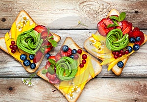 Sandwich with avocado,fruits and berries