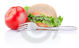 Sandwich bun with lettuce, tomato and fork isolated