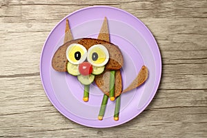 Sandwich cat made on purple plate and wooden background