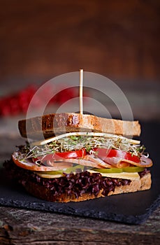 Sandwich with cereals bread with lettuce,ham, prosciutto