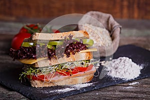 Sandwich with cereals bread with lettuce,ham, prosciutto