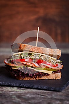 Sandwich with cereals bread with lettuce,ham, prosciutto