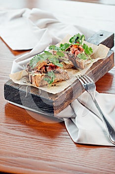 Sandwich with cereals bread and salmon on dark marble background