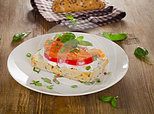 Sandwich with cereals bread and salmon on a old wooden backgroun