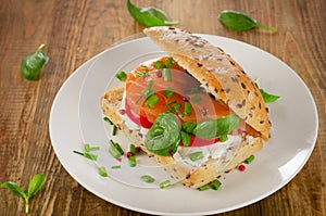 Sandwich with cereals bread and salmon on wooden table.