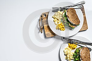 Sandwich with chicken breast, arugula, omelette and corn. White background. Top view. Copy space