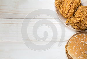 Sandwich with chicken burger on wooden plate. on top