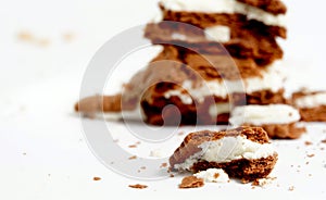 Sandwich cookies, chocolate and vanilla cream filled biscuits isolated on white background