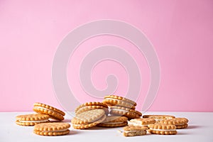 Sandwich cookies on a pink background. The concept of breakfast and a quick snack