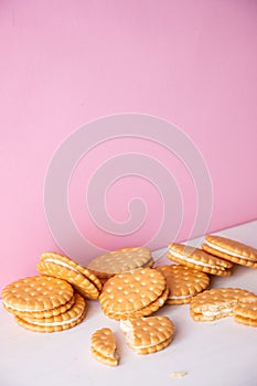 Sandwich cookies on a pink background. The concept of breakfast and a quick snack