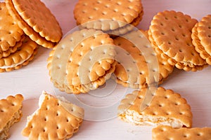 Sandwich cookies on a pink background. The concept of breakfast and a quick snack