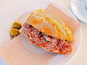 Sandwich with delicious delicaty dried sausage Fuet