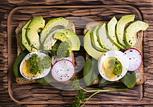 Sandwich with egg, lunch breakfast , tasty radish greens on old background