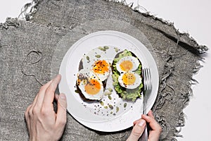 Sandwich with fresh vegetables, avocado, hard-boiled eggs and pumpkin seeds with olive oil and bread. healthy diet or