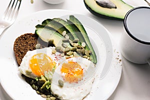 Sandwich with fresh vegetables, avocado, hard-boiled eggs and pumpkin seeds with olive oil and bread. healthy diet or