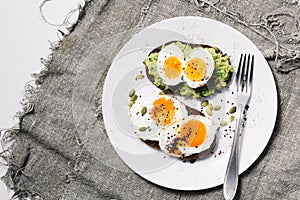 Sandwich with fresh vegetables, avocado, hard-boiled eggs and pumpkin seeds with olive oil and bread. healthy diet or