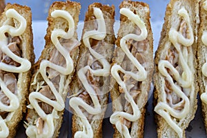 Sandwich with fried bacon and mayonnaise for sell at street food market in Thailand . Tasty sandwich close up