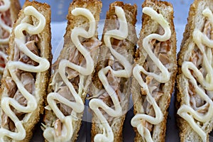 Sandwich with fried bacon and mayonnaise for sell at street food market in Thailand . Tasty sandwich close up