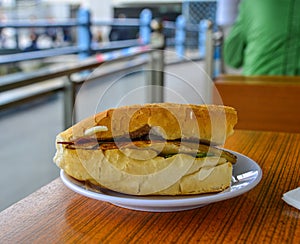 Sandwich with fried fish and vegetables