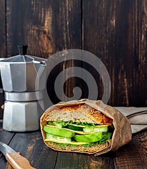 Sandwich with green salad, avocado, cucumber and cheese. Healthy eating. Vegetarian food. Breakfast