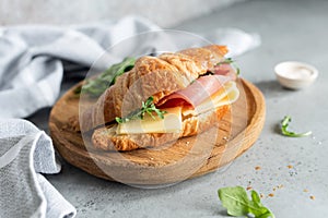 Sandwich with ham and cheese on croissant bun