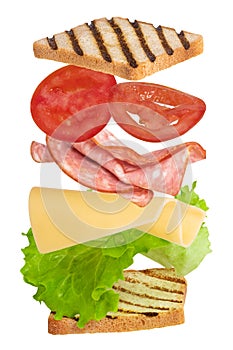 Sandwich with ham, cheese, tomato, lettuce and toasted bread isolated on a white background