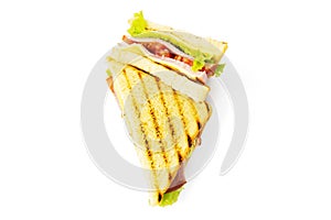 Sandwich with ham, cheese, tomatoes, lettuce, and toasted bread. Above view isolated on white background