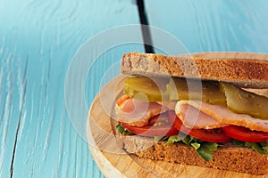 Sandwich with ham, cucumber, tomato closeup