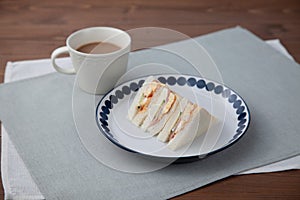 sandwich with ham egg cafe latte isolated on table