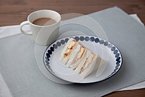 sandwich with ham egg cafe latte isolated on table