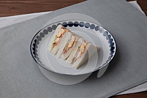 sandwich with ham egg isolated on table