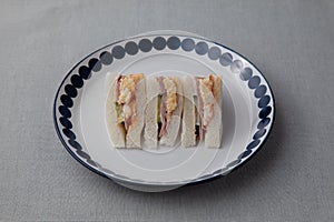 sandwich with ham egg isolated on table